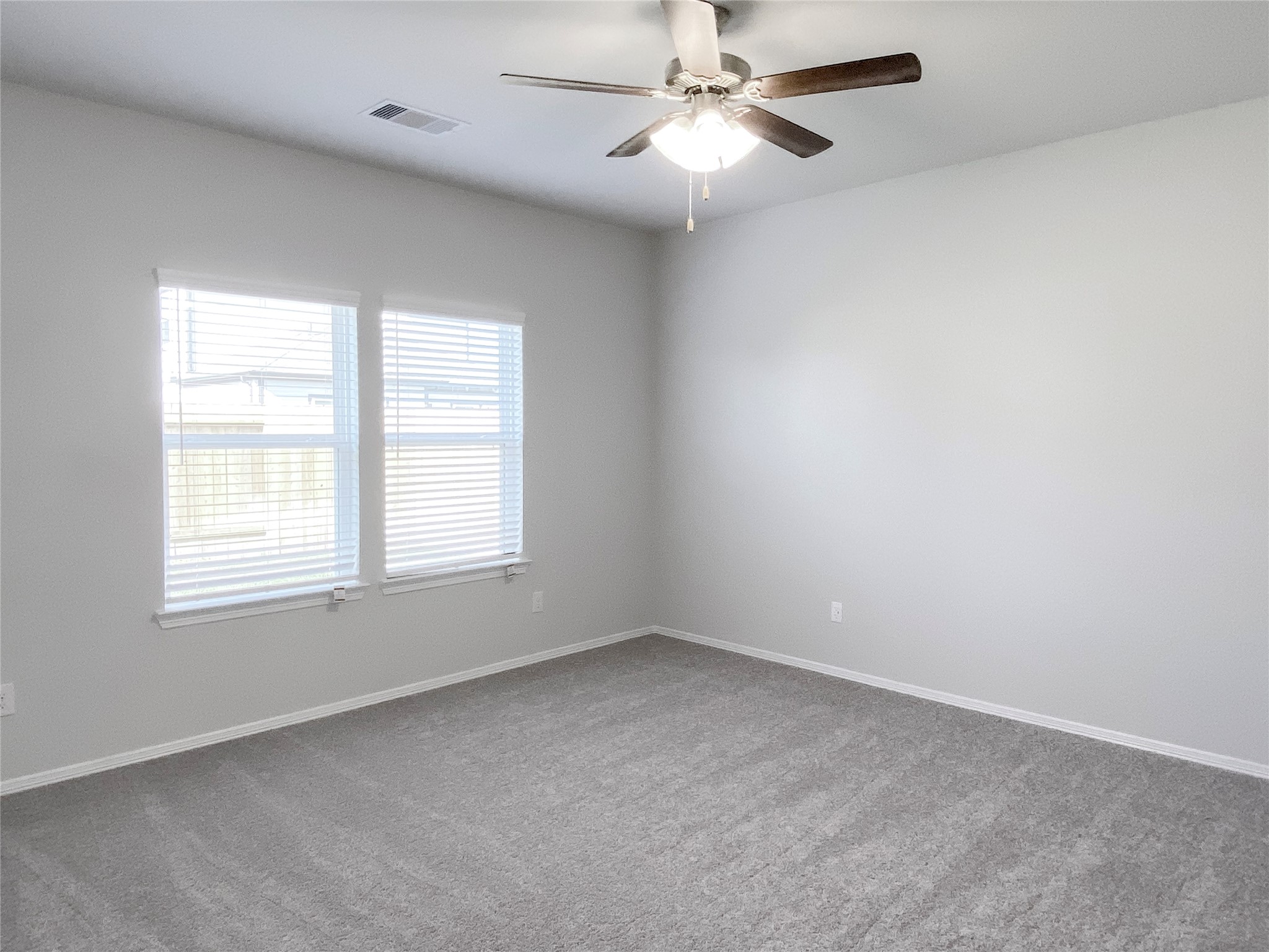 23338 Spring Genesis Lane Katy, TX 77493 - Photo 12 of 18 The master bedroom is tucked in the back of the house overlooking the backyard