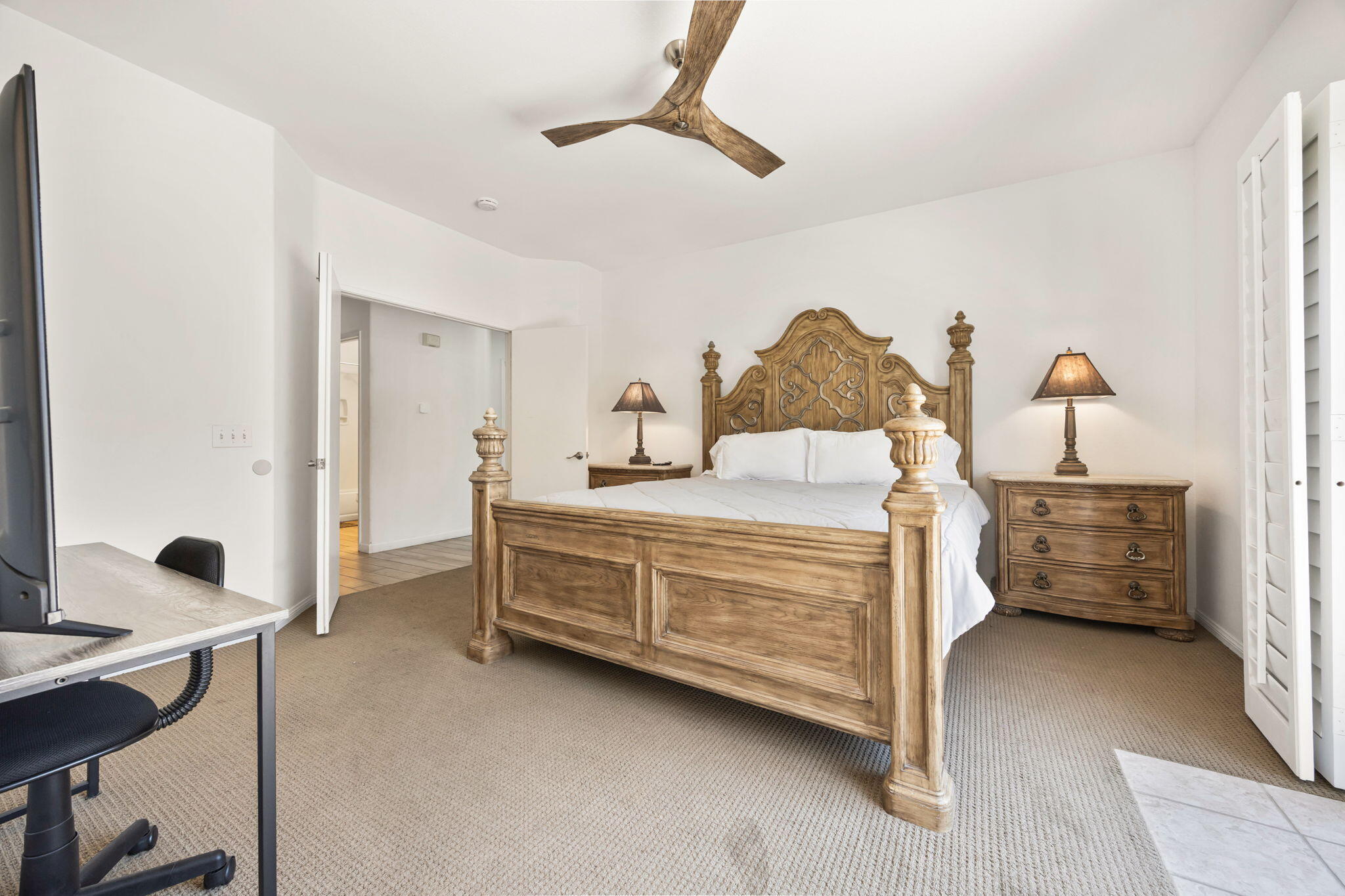 48701 Gibraltar Street Indio, CA 92201 - Photo 15 of 52 a bedroom with a bed and a chandelier