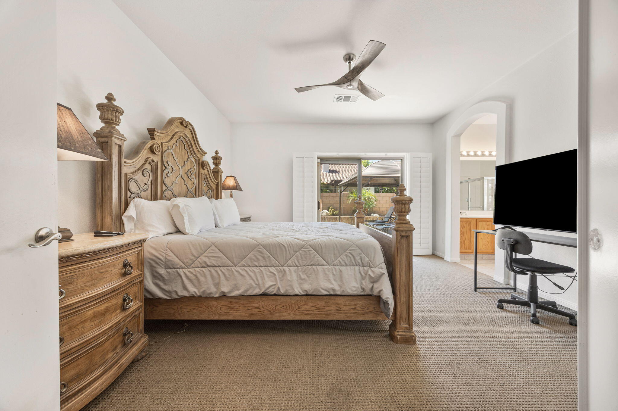 48701 Gibraltar Street Indio, CA 92201 - Photo 16 of 52 a bedroom with a bed and a flat screen tv