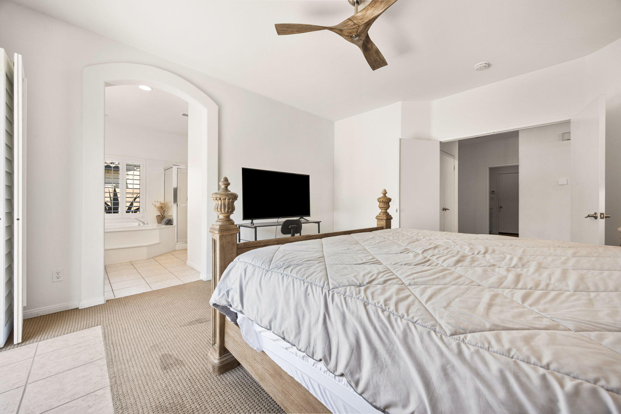 48701 Gibraltar Street Indio, CA 92201 - Photo 19 of 52 a bedroom with a bed and a flat tv screen
