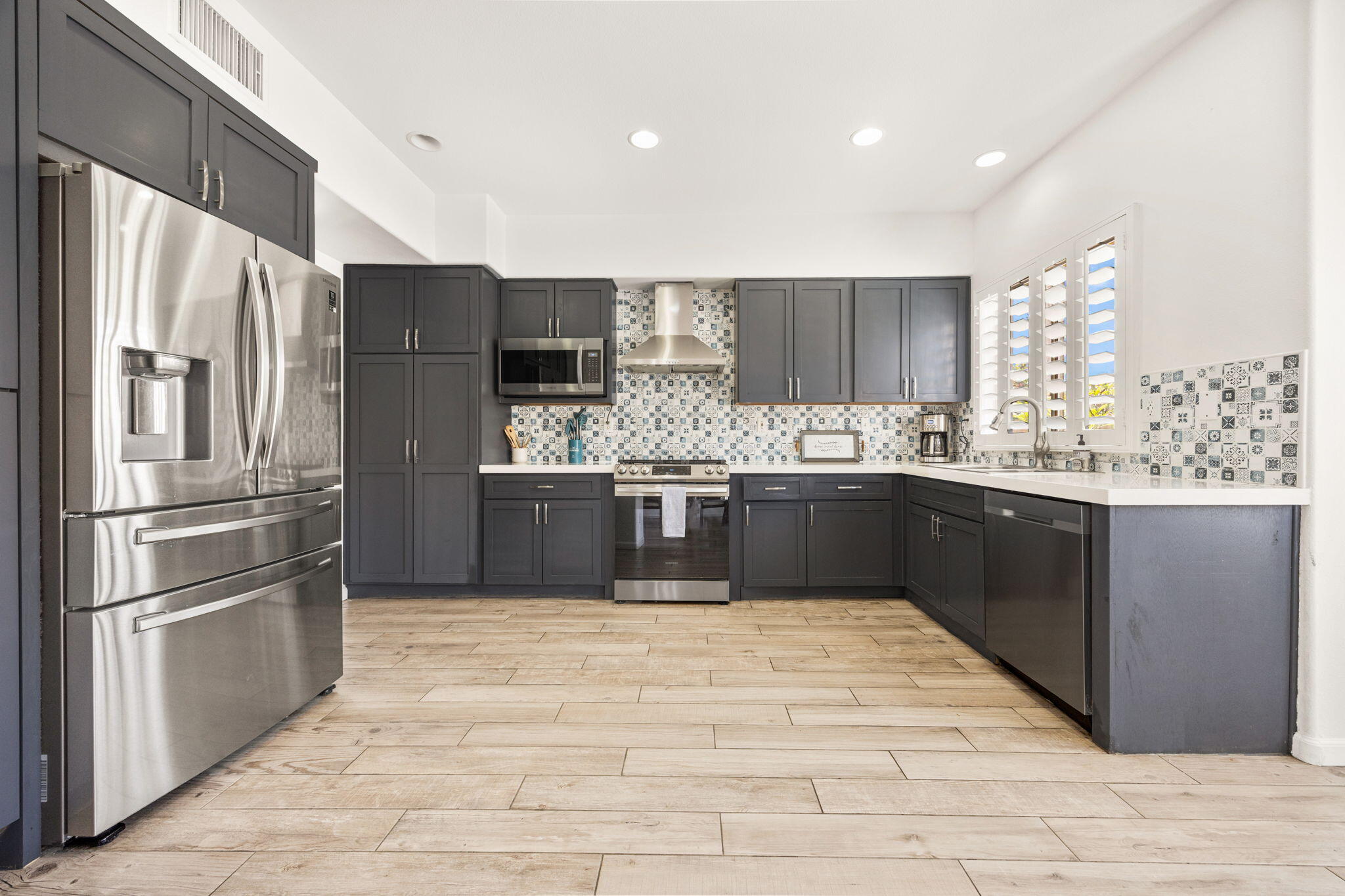 48701 Gibraltar Street Indio, CA 92201 - Photo 2 of 52 a kitchen with stainless steel appliances granite countertop a refrigerator a sink a stove and a oven
