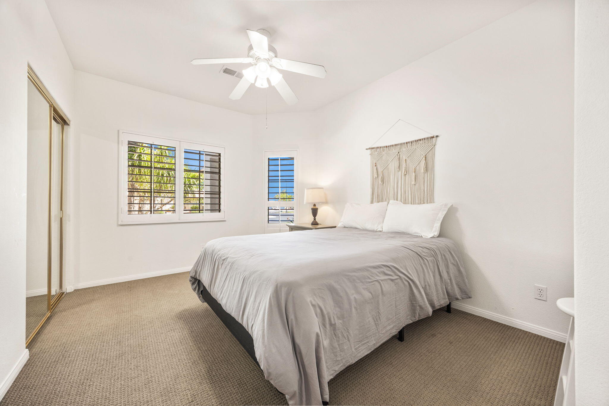 48701 Gibraltar Street Indio, CA 92201 - Photo 31 of 52 a bedroom with a bed and a chandelier
