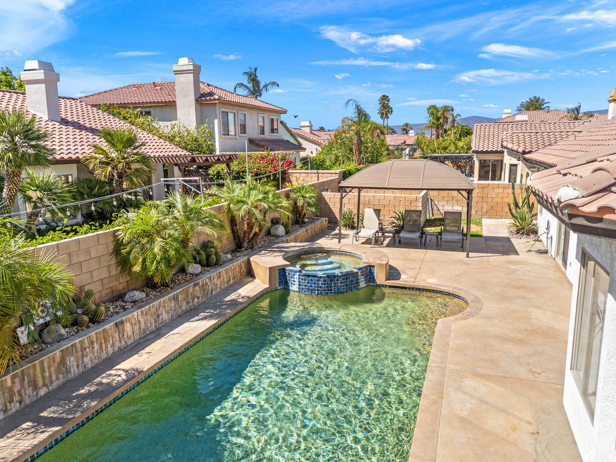 48701 Gibraltar Street Indio, CA 92201 - Photo 34 of 52 a view of a swimming pool with a patio