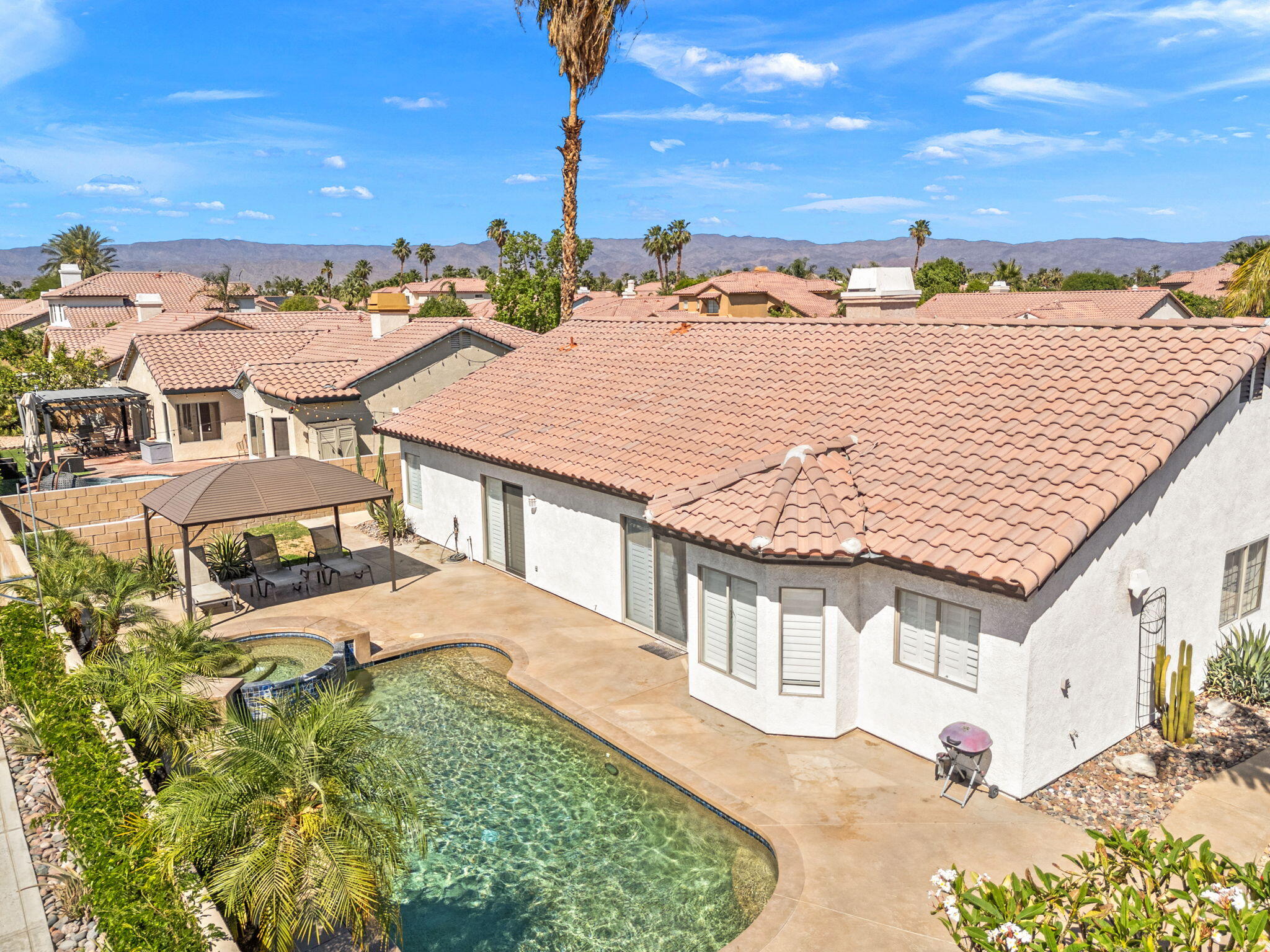 48701 Gibraltar Street Indio, CA 92201 - Photo 35 of 52 an aerial view of residential houses with outdoor space