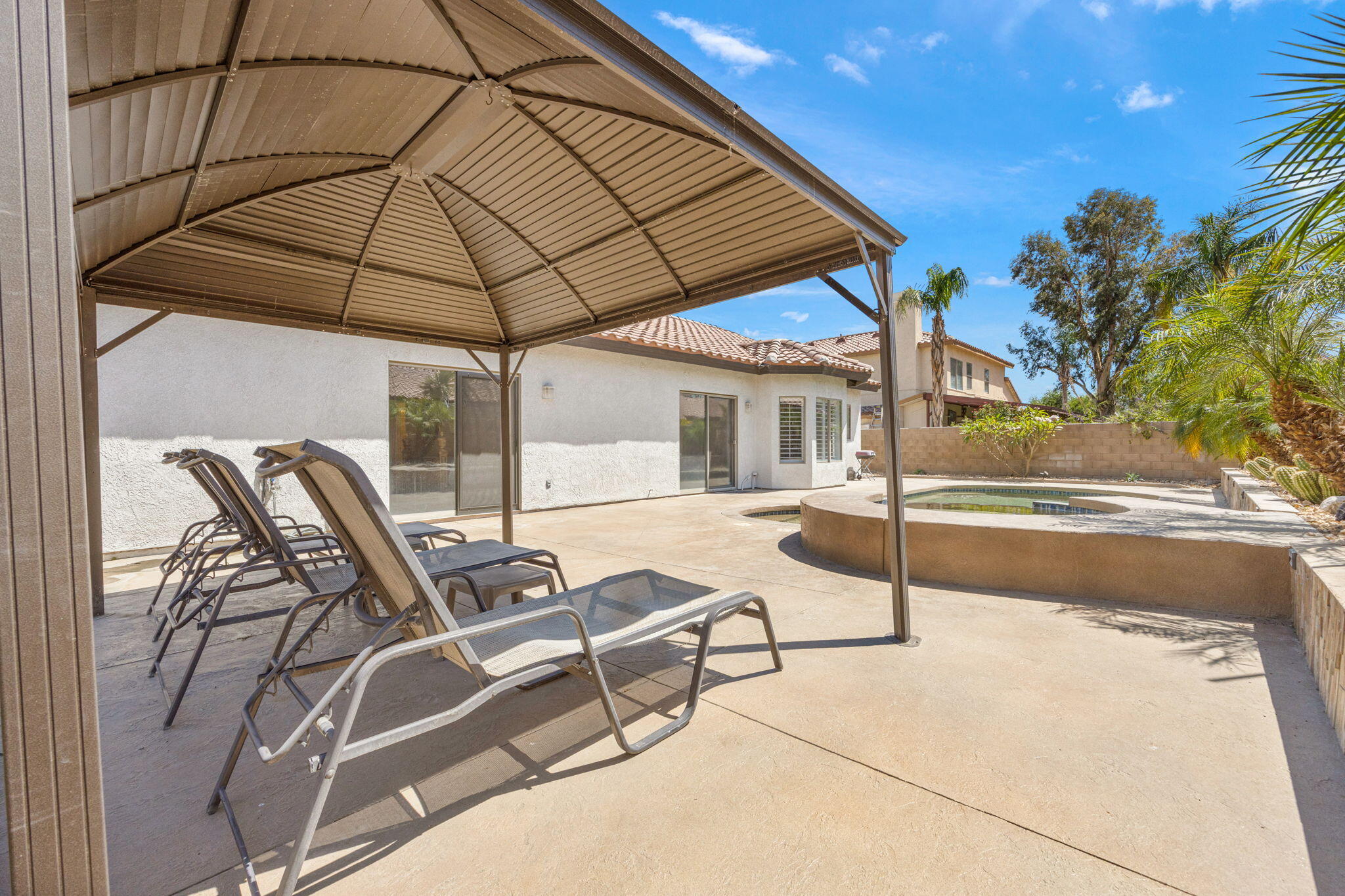 48701 Gibraltar Street Indio, CA 92201 - Photo 36 of 52 a view of patio with table and chairs under an umbrella