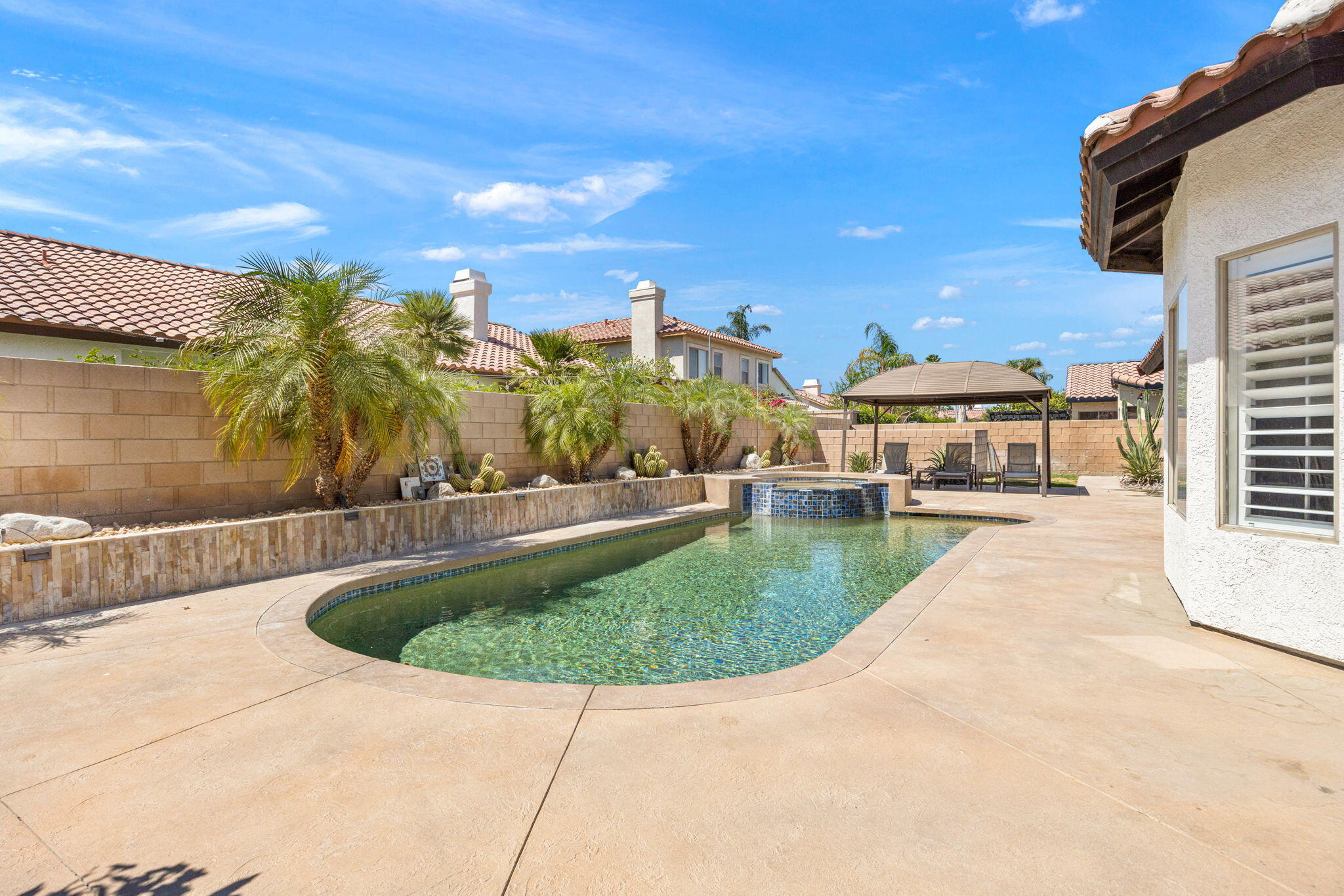 48701 Gibraltar Street Indio, CA 92201 - Photo 42 of 52 a view of a swimming pool with a patio