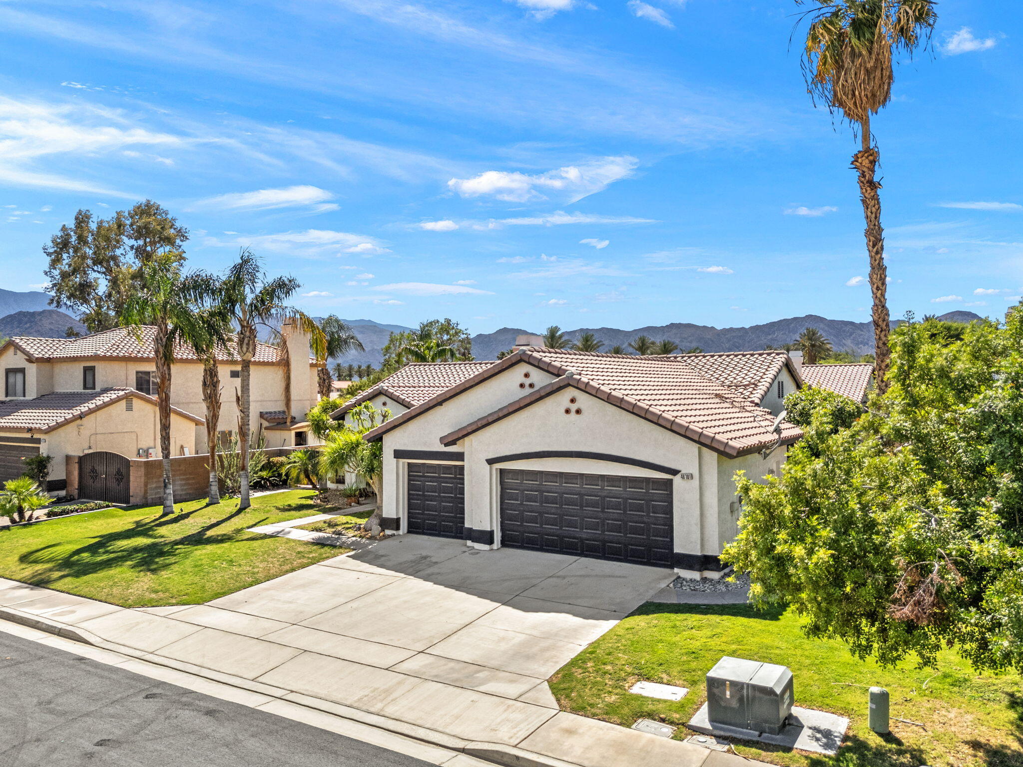 48701 Gibraltar Street Indio, CA 92201 - Photo 48 of 52 a front view of a house with a garden