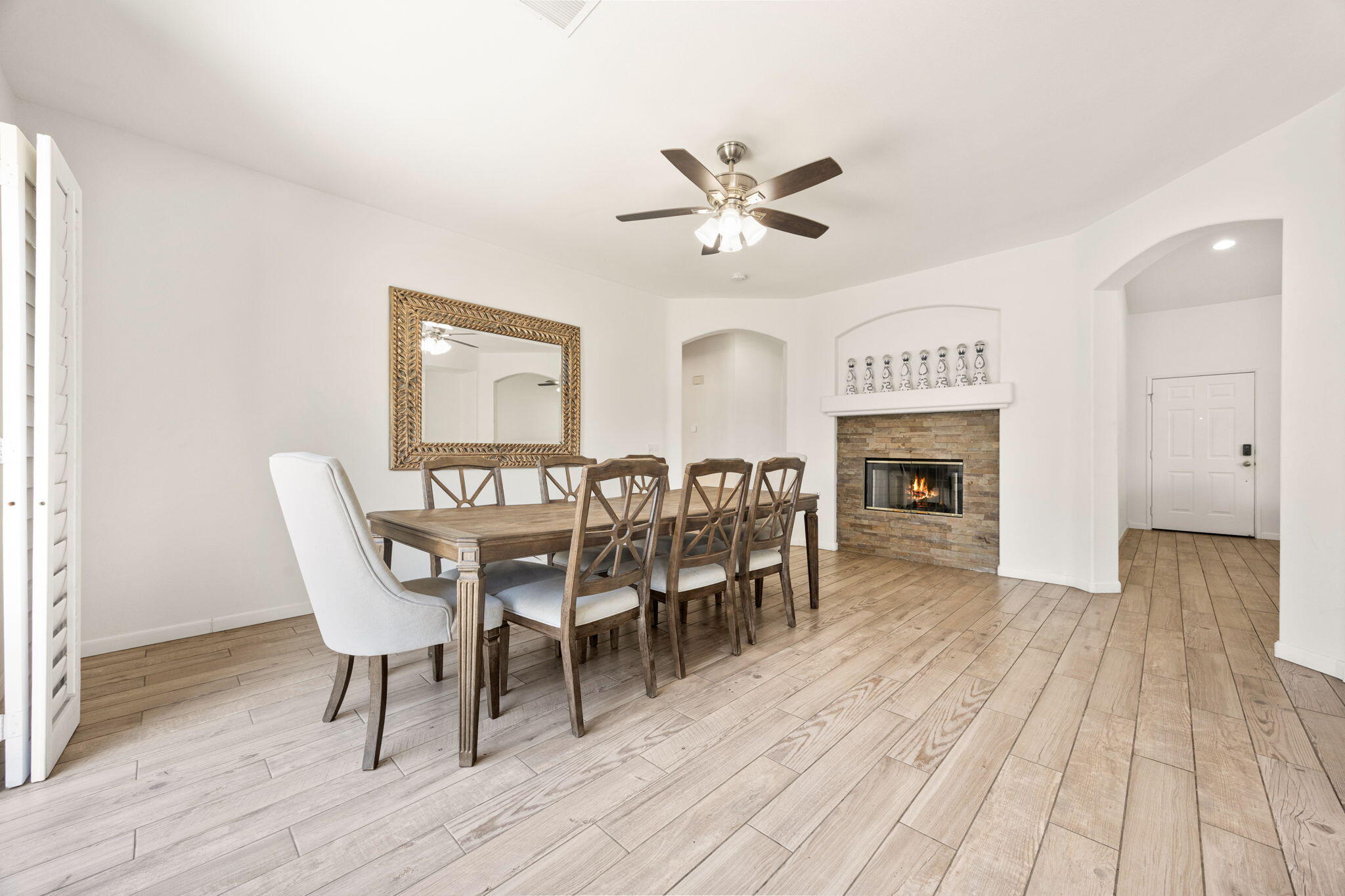 48701 Gibraltar Street Indio, CA 92201 - Photo 9 of 52 a dining room with furniture a fireplace and wooden floor