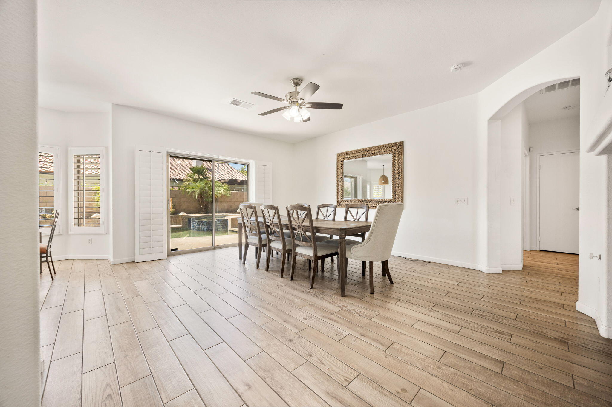 48701 Gibraltar Street Indio, CA 92201 - Photo 10 of 52 a view of a dining room with furniture window and wooden floor