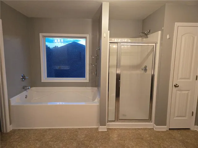 a bathroom with a tub and shower