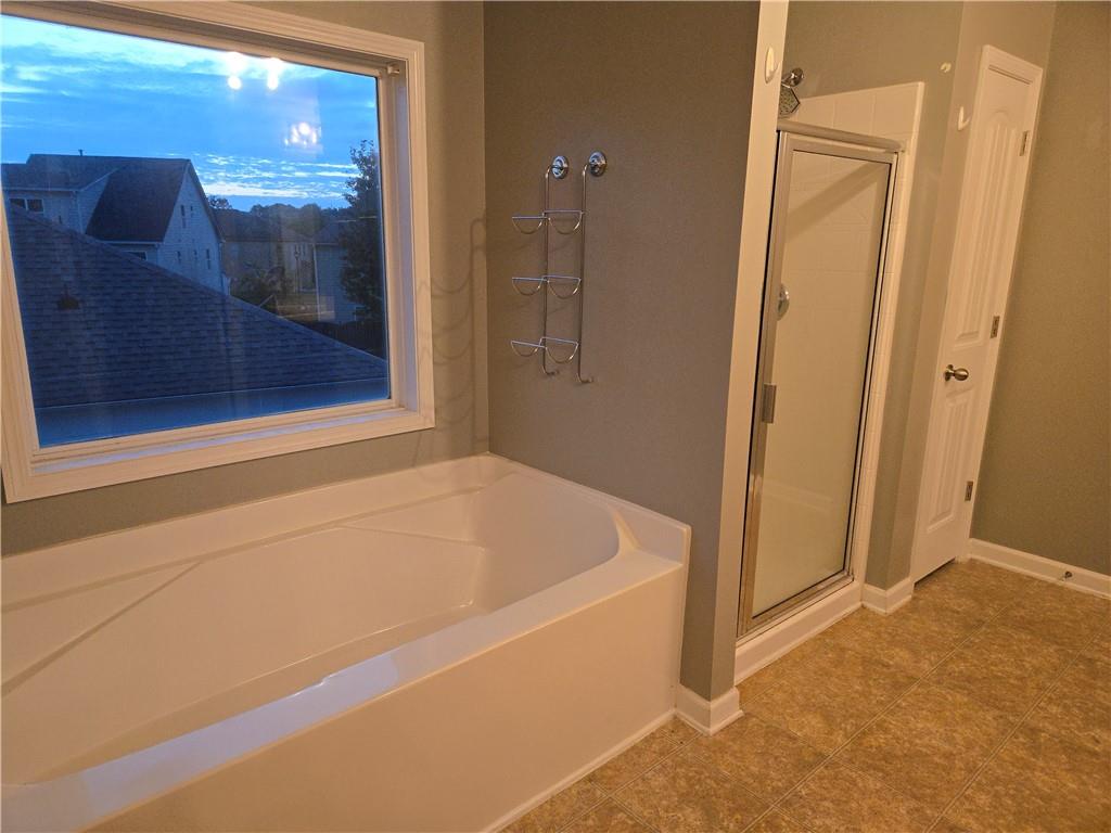 4613 Irish Red Court Union City, GA 30291 - Photo 13 of 15 a bathroom with a tub and shower