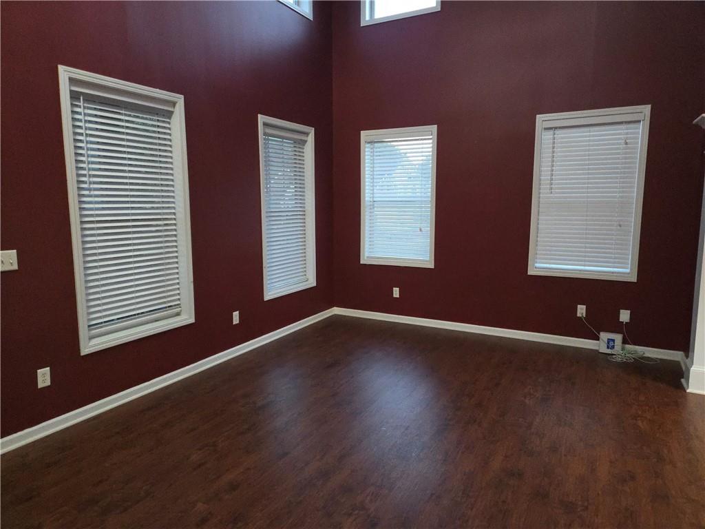 4613 Irish Red Court Union City, GA 30291 - Photo 4 of 15 a view of an empty room with wooden floor and a window
