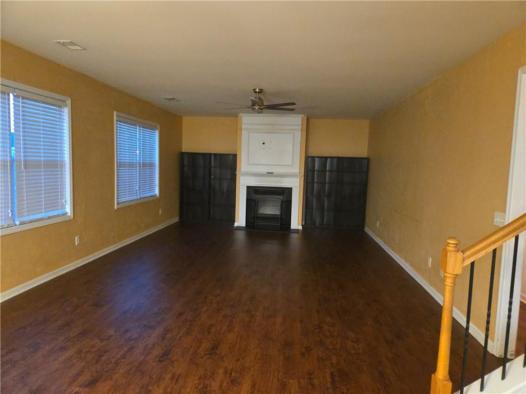 4613 Irish Red Court Union City, GA 30291 - Photo 7 of 15 a view of a livingroom with wooden floor and a ceiling fan