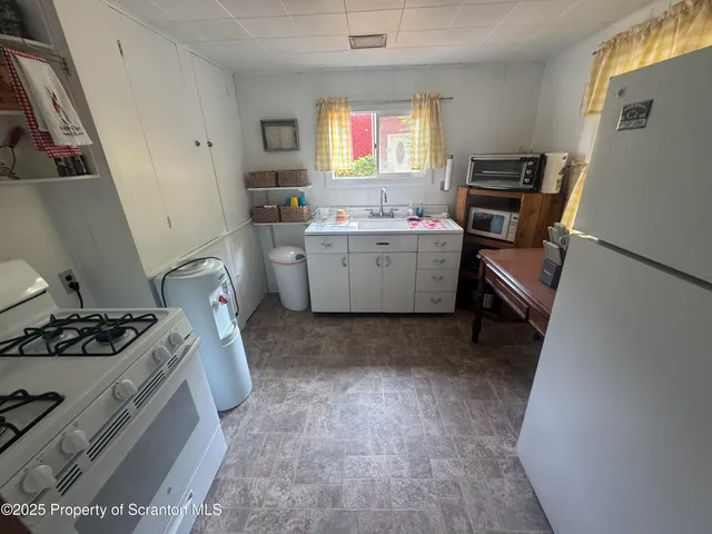 a room with a window a washer and dryer