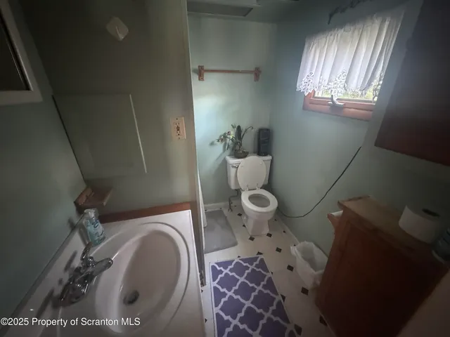 a bathroom with a toilet and a sink