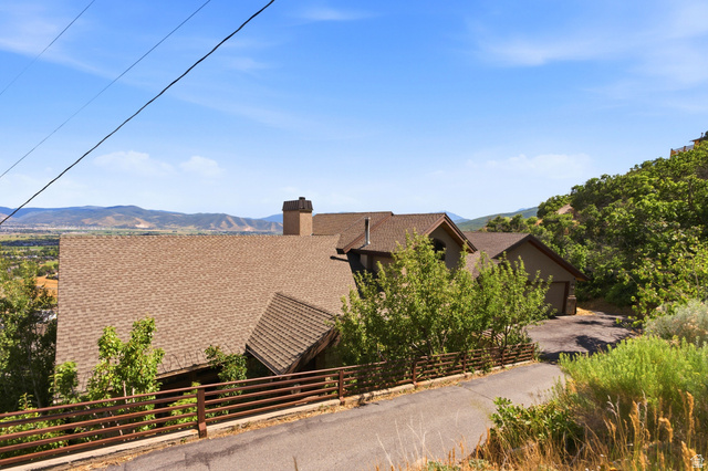 335 Bern Way Midway, UT 84049 - Photo 82 of 88 Terraced property featuring a multi-level roofline with asphalt shingles, a prominent chimney, and an integrated garage