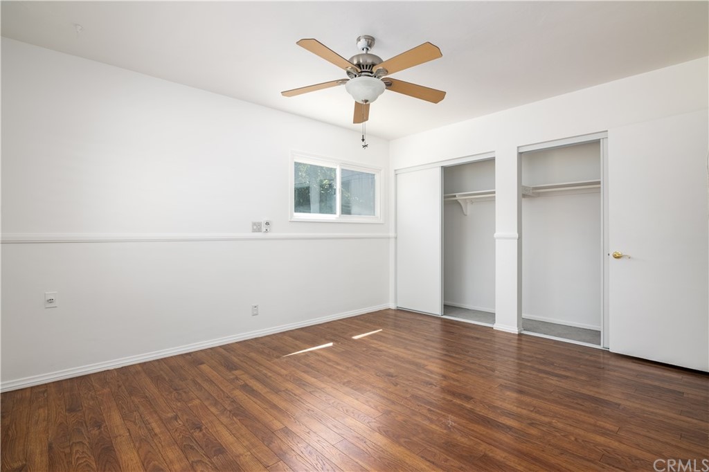 166 Barret Road Riverside, CA 92507 - Photo 11 of 30 an empty room with wooden floor and ceiling fan