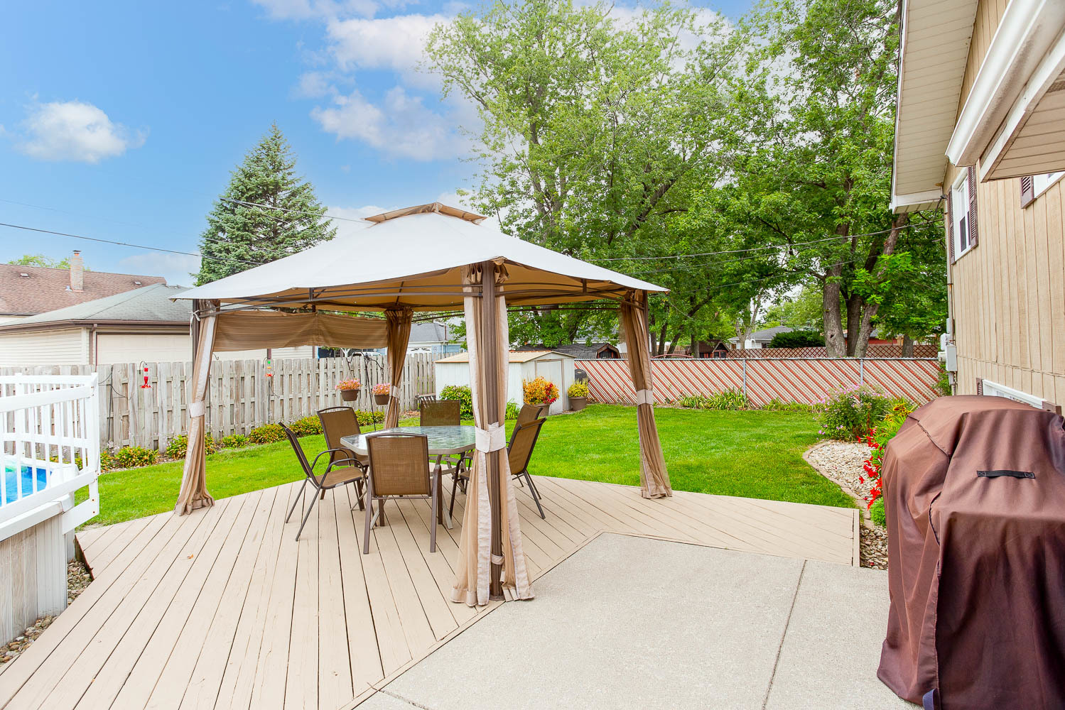 17936 Dekker Avenue Lansing, IL 60438 - Photo 11 of 35 a view of a patio with a table chairs and a yard