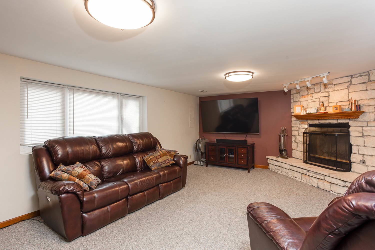 17936 Dekker Avenue Lansing, IL 60438 - Photo 20 of 35 a living room with furniture a flat screen tv and a fireplace