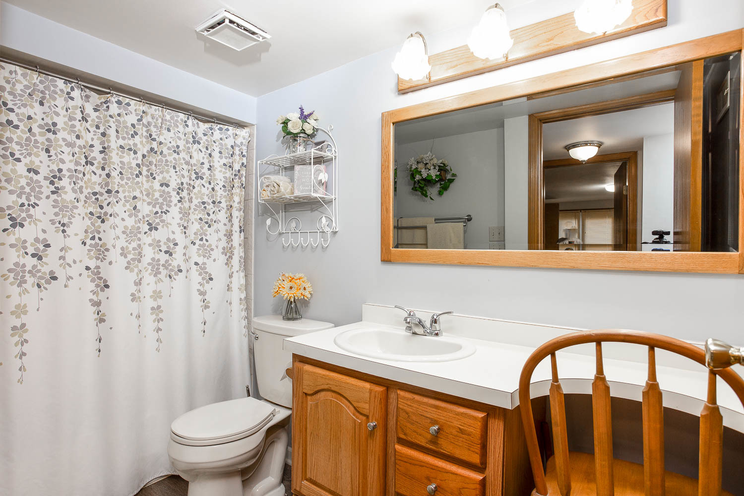 17936 Dekker Avenue Lansing, IL 60438 - Photo 24 of 35 a bathroom with a sink a toilet and a mirror