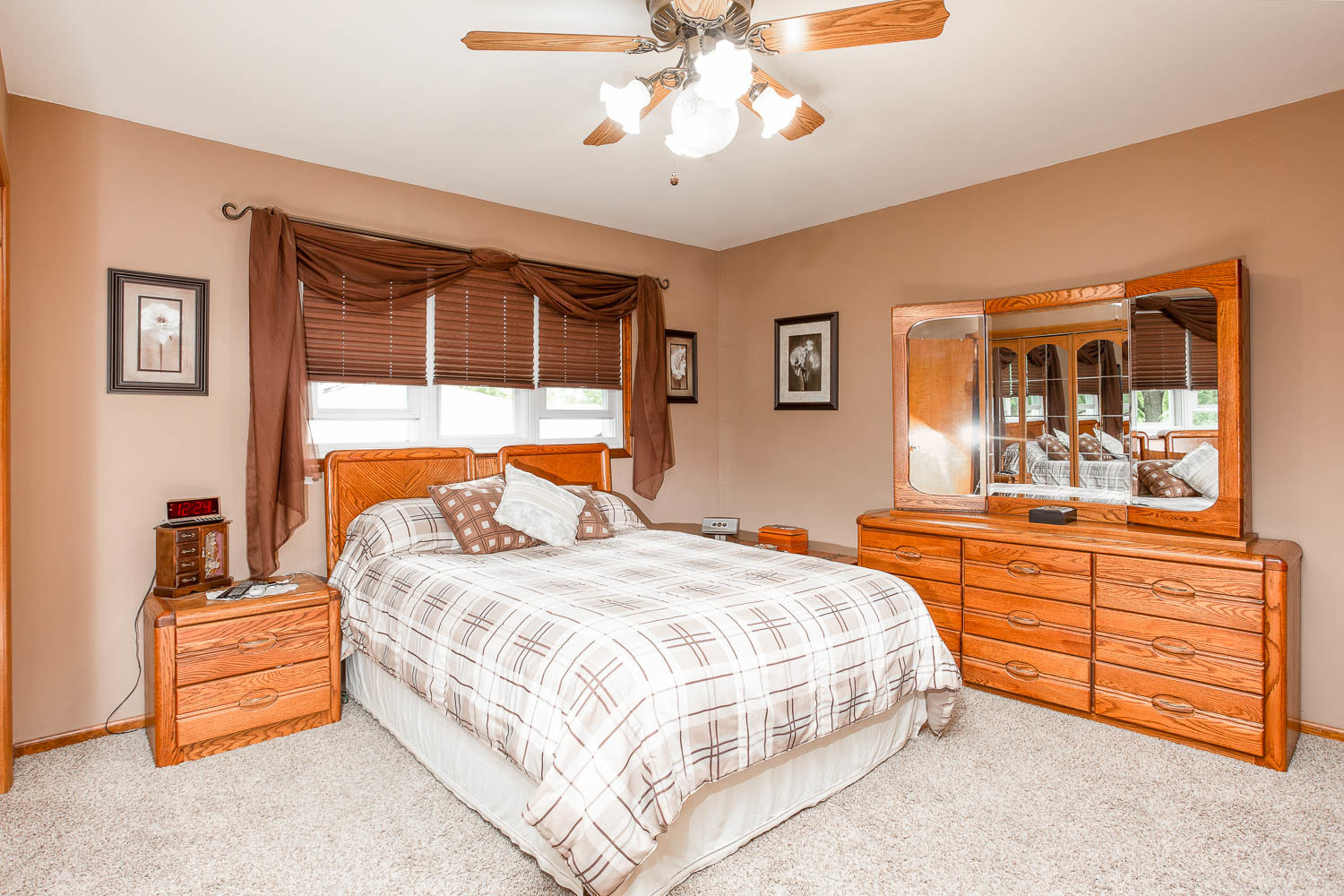17936 Dekker Avenue Lansing, IL 60438 - Photo 32 of 35 a bedroom with a bed and a dresser