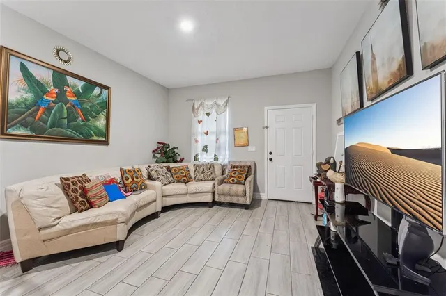 a living room with furniture and wooden floor
