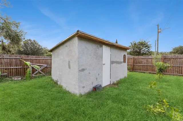 a view of a backyard with wooden fence and floor