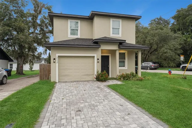 a front view of house with yard and green space
