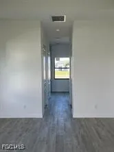 a view of an empty room and a window