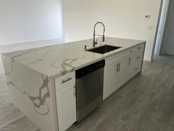 a kitchen with a sink and cabinets
