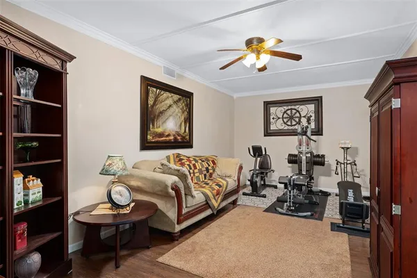 a living room with furniture a flat screen tv and a lamp