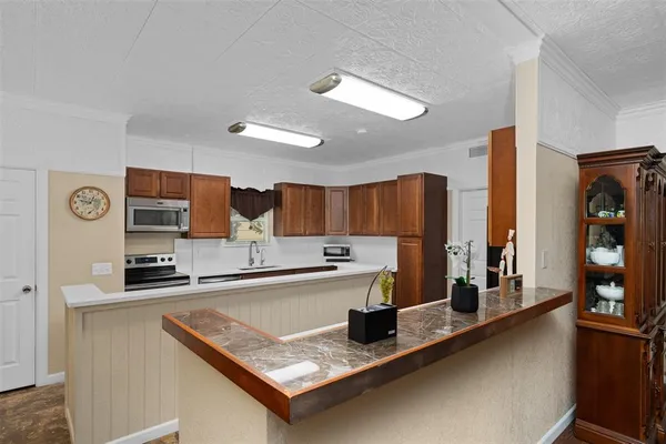 a kitchen with a sink a counter top space and cabinets
