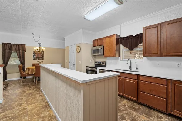 a kitchen with center island and stainless steel appliances