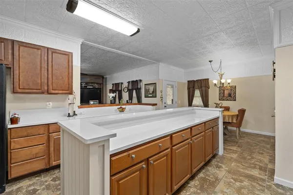 a kitchen with a stove dining table and chairs