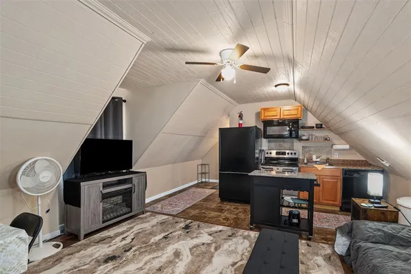 a bedroom with a bed and a ceiling fan