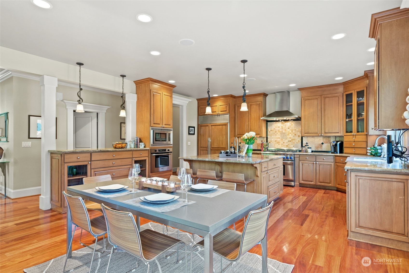 10707 226th Street Southwest Edmonds, WA 98020 - Photo 14 of 39 a kitchen with stainless steel appliances kitchen island granite countertop a table chairs and a stove