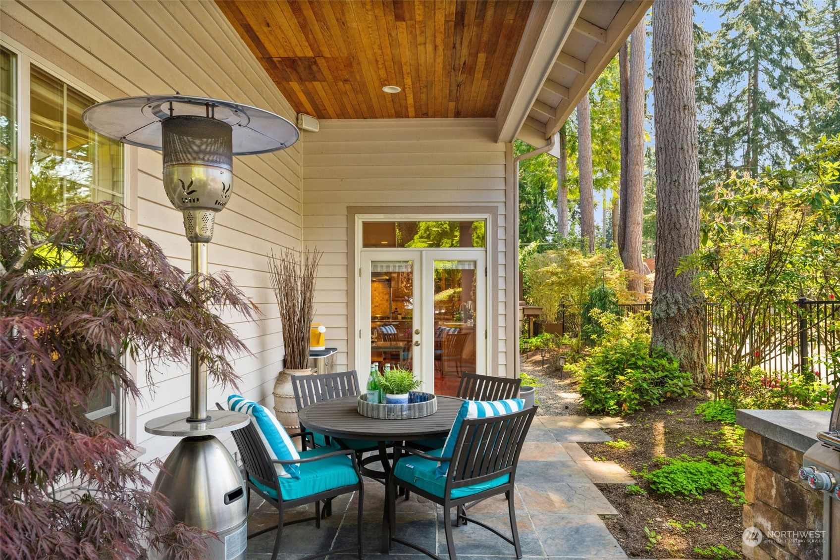 10707 226th Street Southwest Edmonds, WA 98020 - Photo 39 of 39 a view of a patio with table and chairs and potted plants
