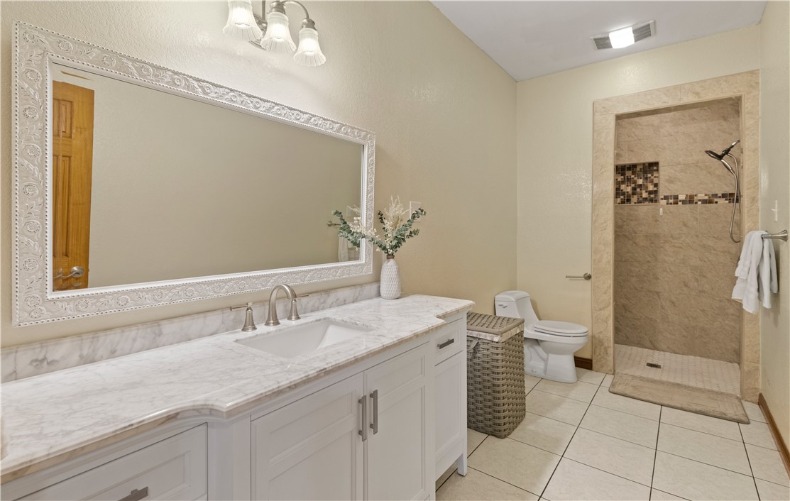 5763 Santa Isabelle Drive Robstown, TX 78380 - Photo 19 of 26 a bathroom with a sink a toilet and shower