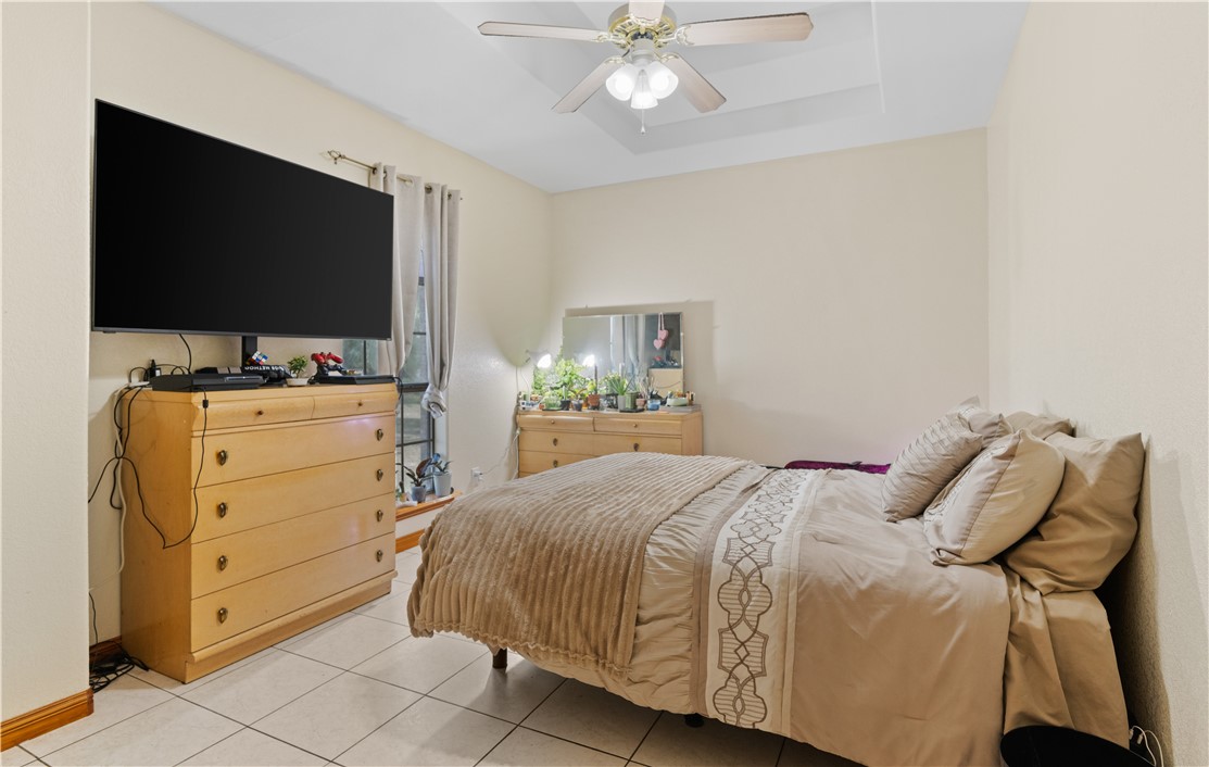 5763 Santa Isabelle Drive Robstown, TX 78380 - Photo 20 of 26 a bedroom with a bed and flat screen tv