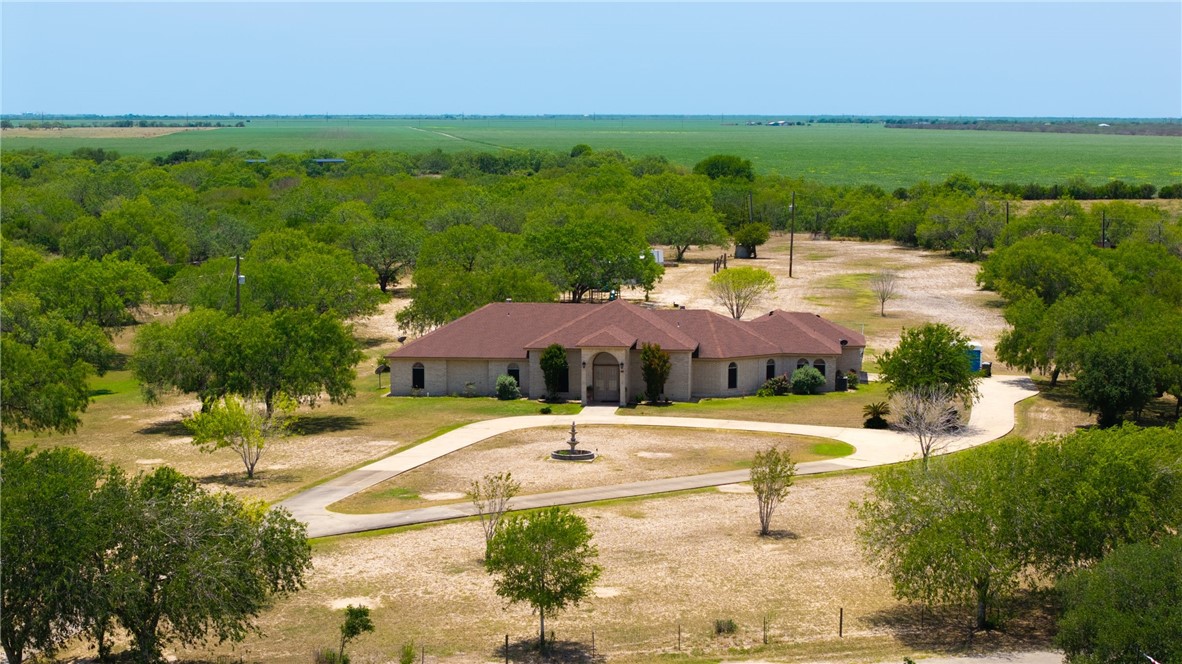 5763 Santa Isabelle Drive Robstown, TX 78380 - Photo 2 of 26 a view of a patio with a table and chairs under an umbrella