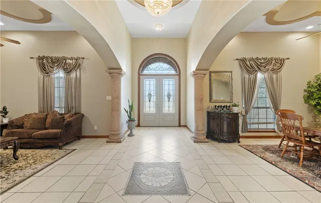 a living room with furniture and a chandelier