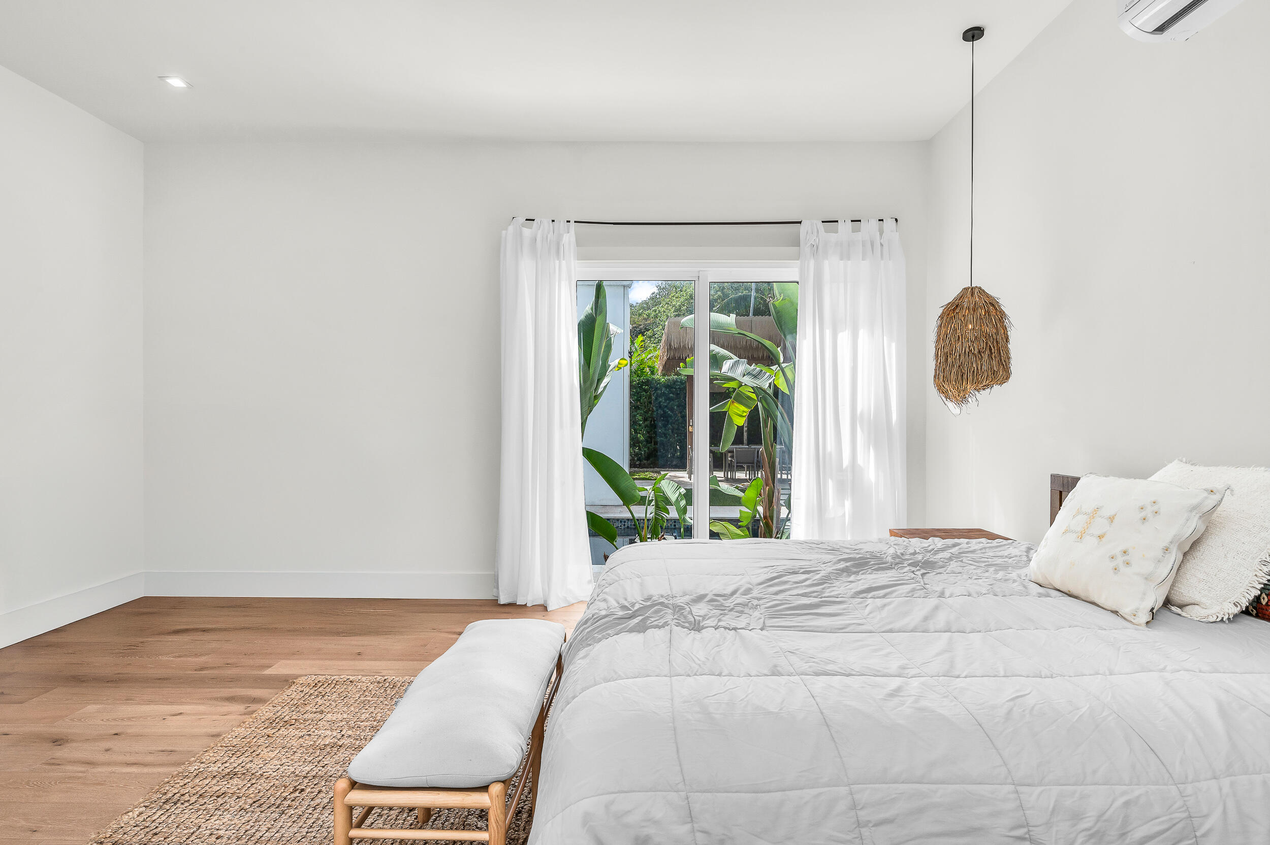 4740 Bay Point Road Miami, FL 33137 - Photo 19 of 27 a bed sitting in a bedroom next to a window