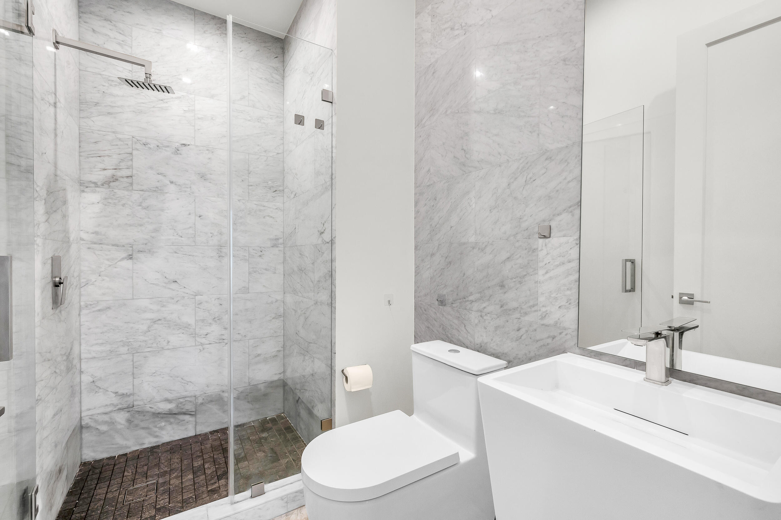 4740 Bay Point Road Miami, FL 33137 - Photo 22 of 27 a bathroom with a sink a toilet and shower