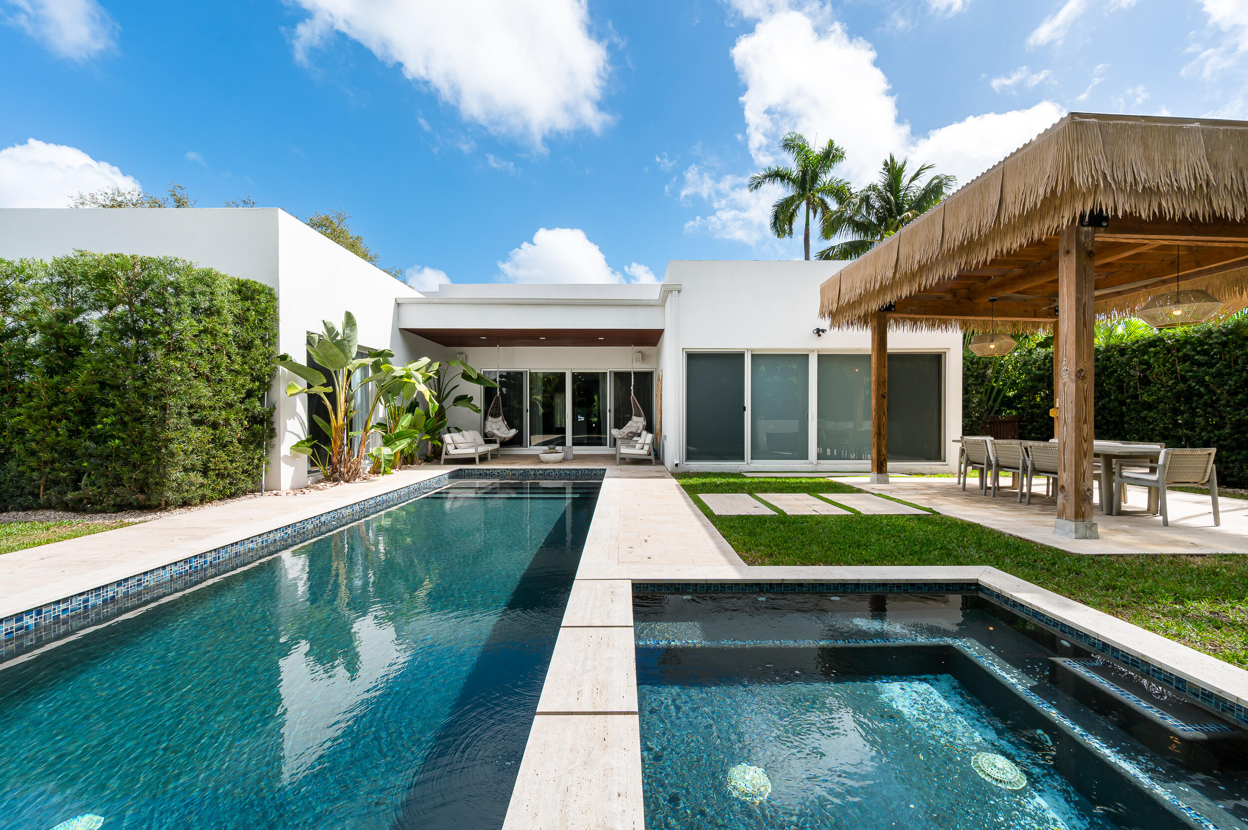 4740 Bay Point Road Miami, FL 33137 - Photo 24 of 27 a view of swimming pool with a lounge chairs in patio