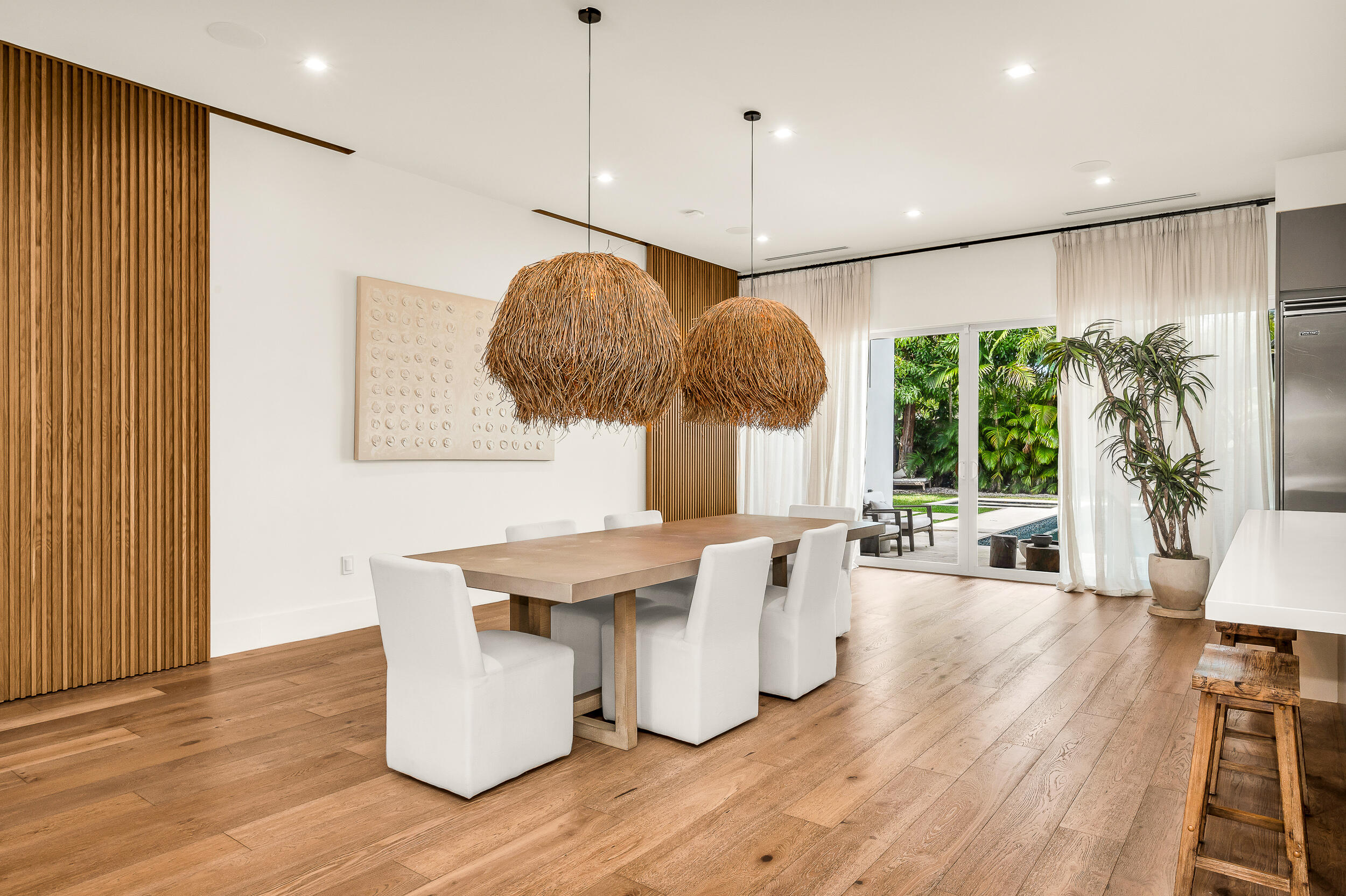 4740 Bay Point Road Miami, FL 33137 - Photo 5 of 27 a kitchen with stainless steel appliances granite countertop a stove a refrigerator a kitchen island with couches wooden floor and cabinets