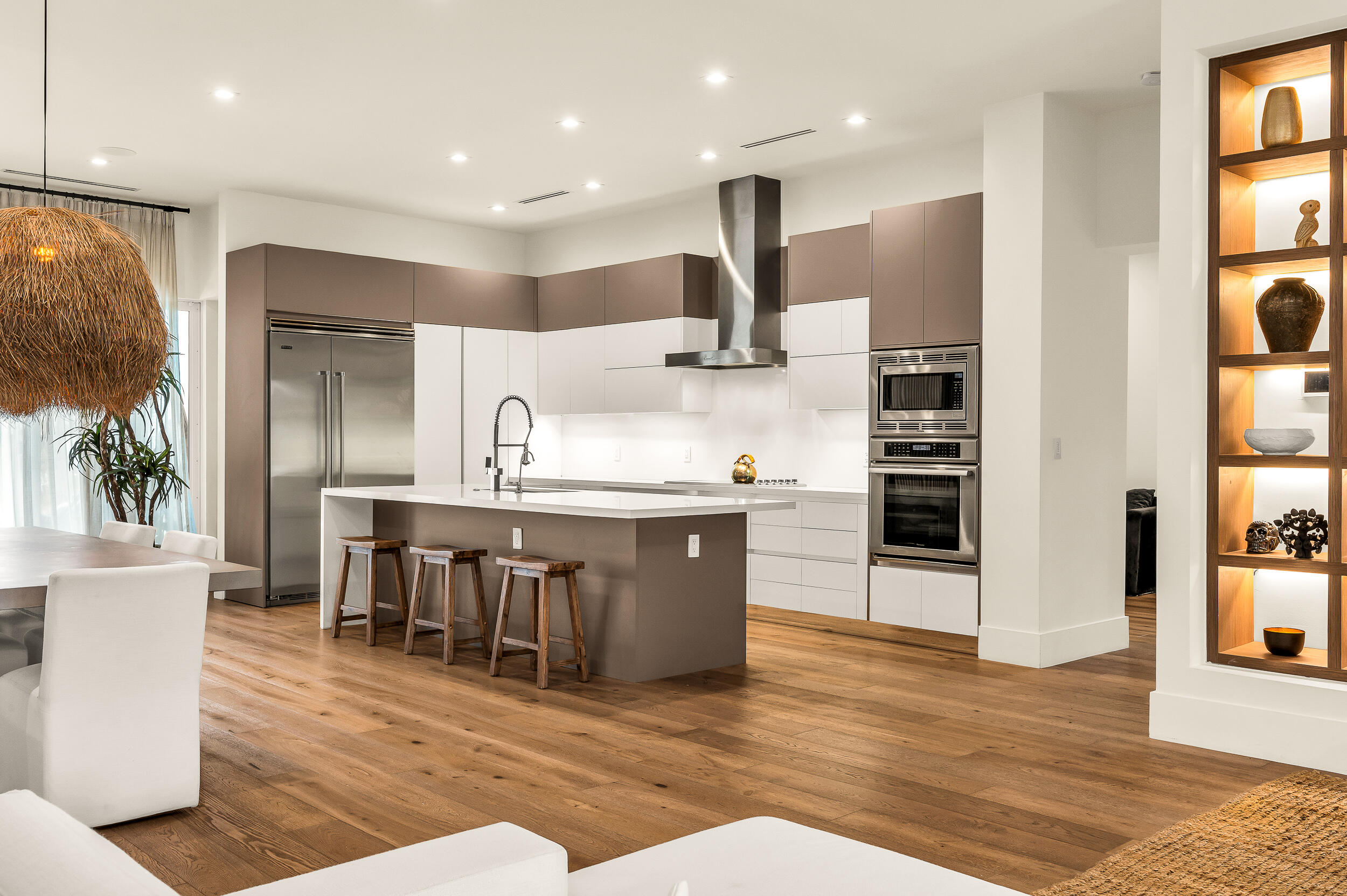 4740 Bay Point Road Miami, FL 33137 - Photo 8 of 27 a large kitchen with stainless steel appliances kitchen island granite countertop a table chairs and a refrigerator