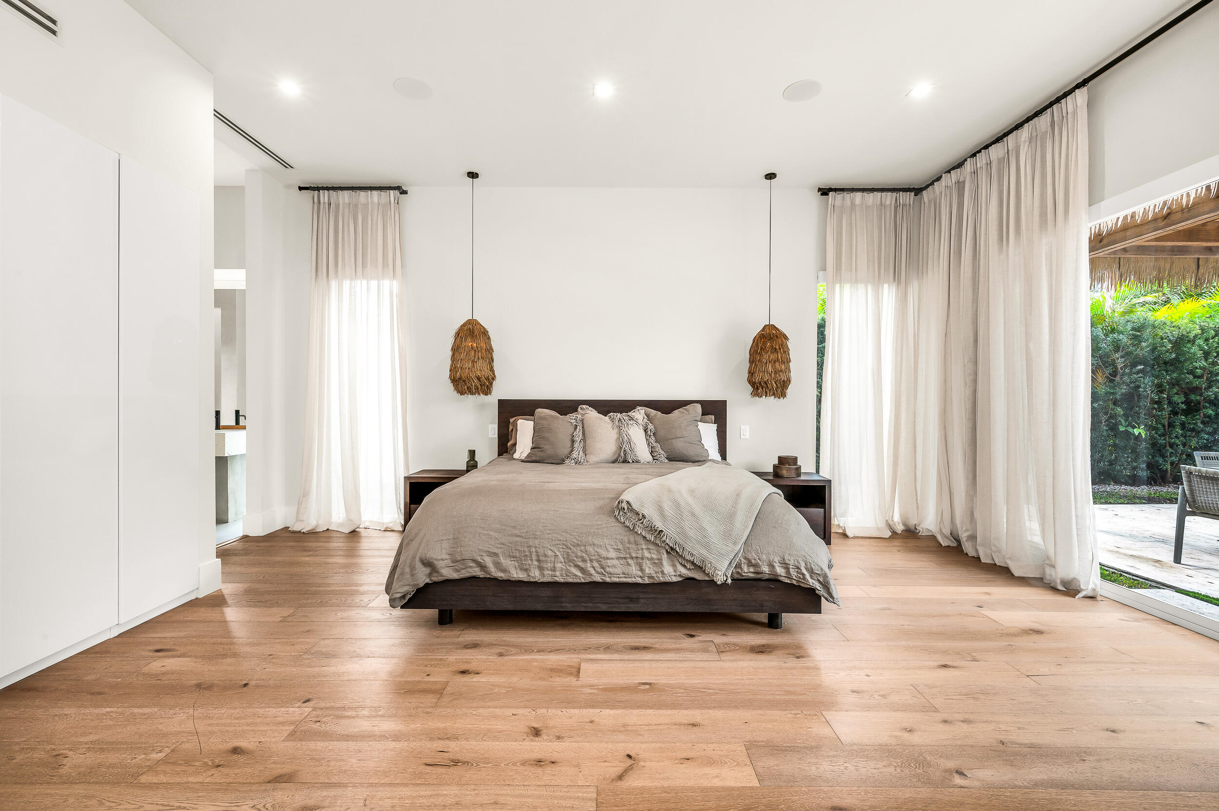 4740 Bay Point Road Miami, FL 33137 - Photo 9 of 27 a spacious bedroom with a bed and a large window