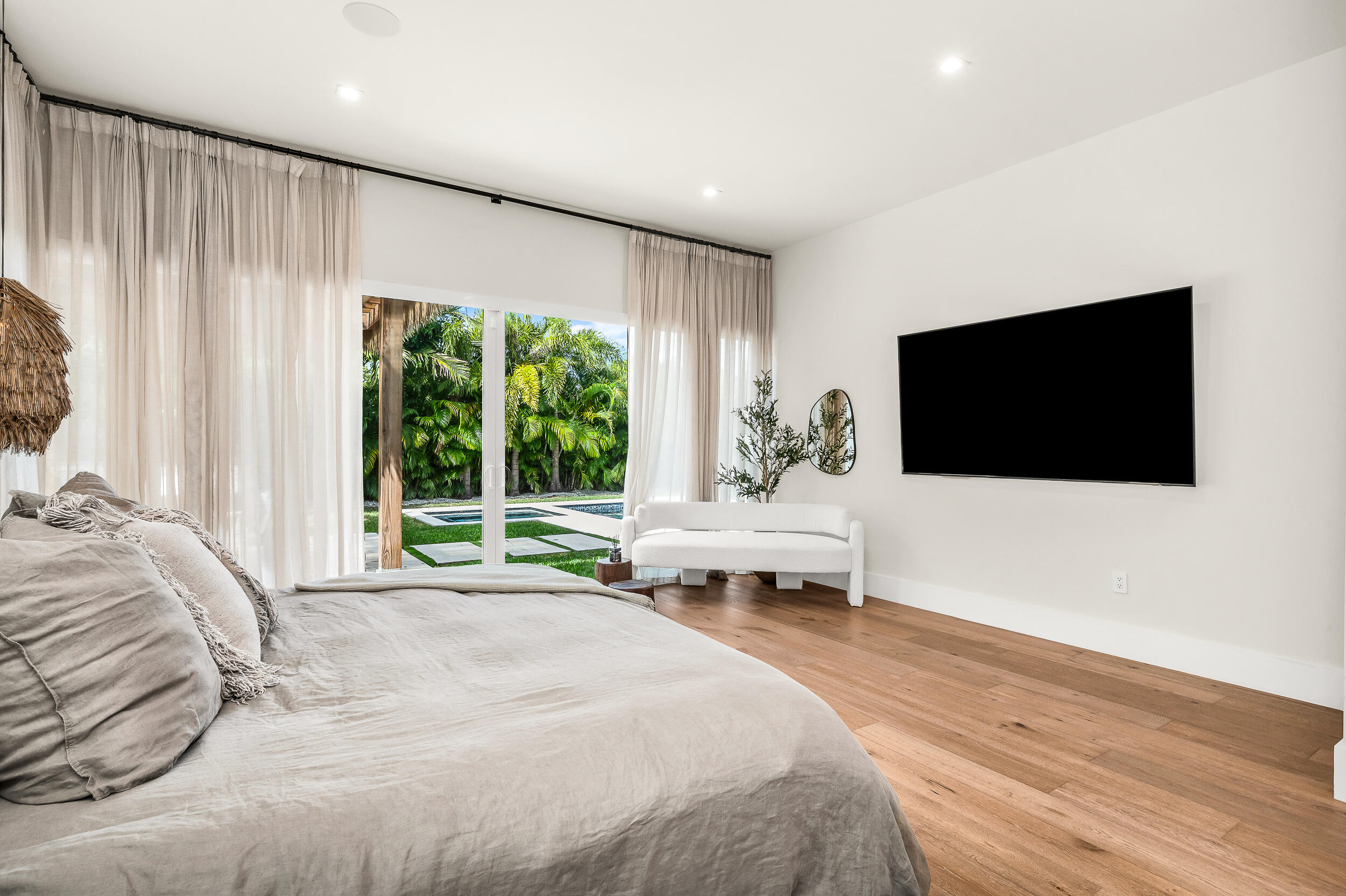 4740 Bay Point Road Miami, FL 33137 - Photo 10 of 27 a bedroom with a bed and a flat screen tv