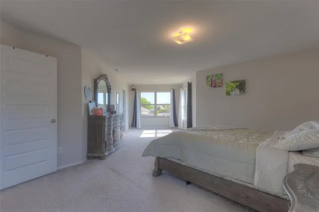 a bedroom with a bed and window