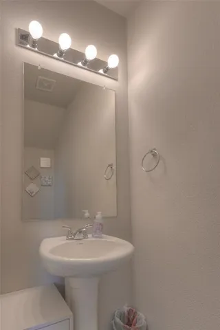 a bathroom with a sink a toilet and mirror